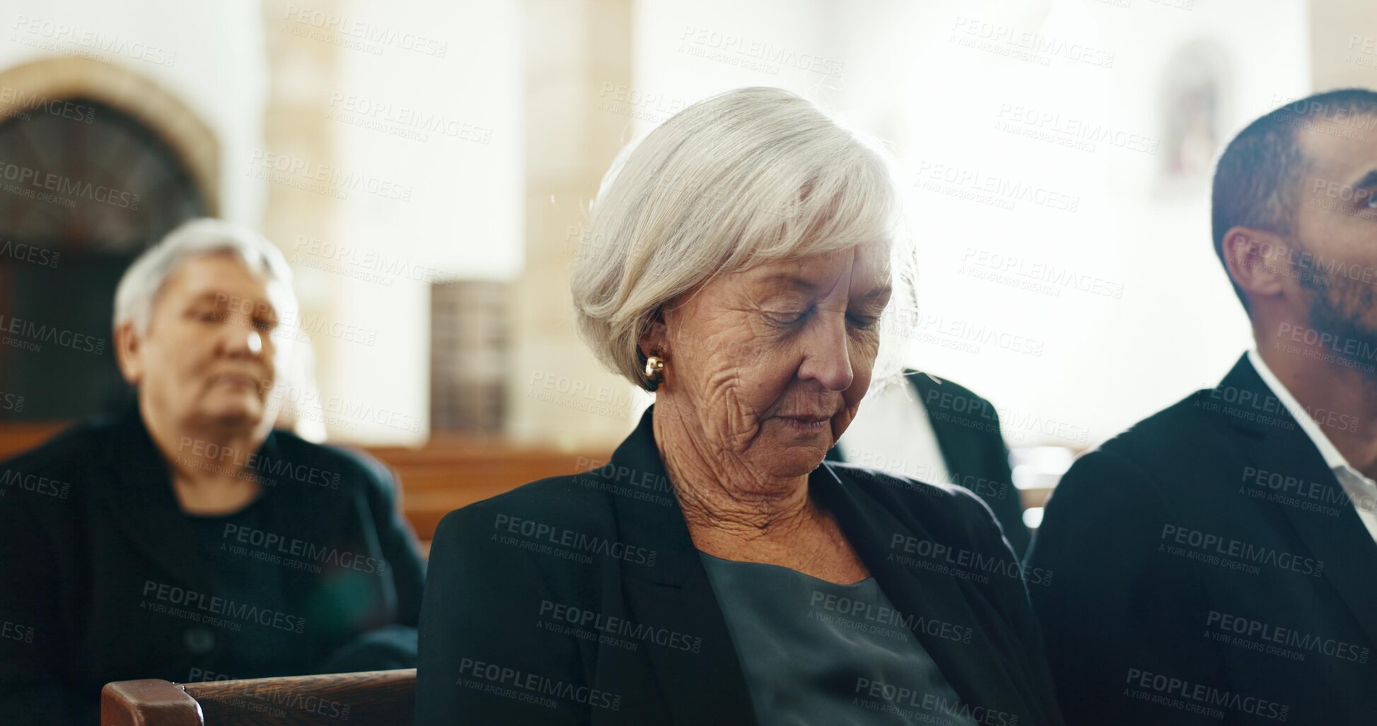 Buy stock photo Sad, bereavement and senior woman at a funeral in church for religious service and mourning. Family, elderly person and burial with death, emotional and grieving loss at a chapel event with people