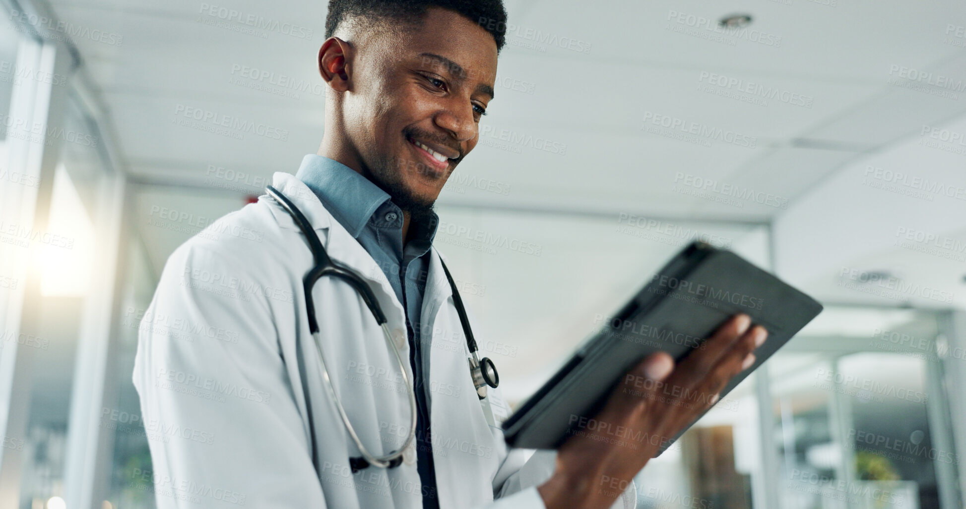 Buy stock photo Tablet, research and happy black man doctor on internet for medical or healthcare information online in a hospital. Smile, medicine and professional typing on health website or app in a modern clinic