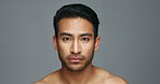 Face, cosmetics and Asian man with beauty, skincare and dermatology on a grey studio background. Portrait, Japanese person and model with wellness, luxury treatment and spa grooming with aesthetic