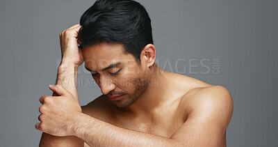 Face, cosmetics and Asian man with beauty, wellness and dermatology on a grey studio background. Portrait, Japanese person or model with healthy skin, luxury treatment and spa grooming with aesthetic