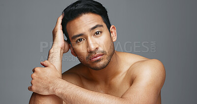 Face, cosmetics and Asian man with beauty, wellness and dermatology on a grey studio background. Portrait, Japanese person or model with healthy skin, luxury treatment and spa grooming with aesthetic