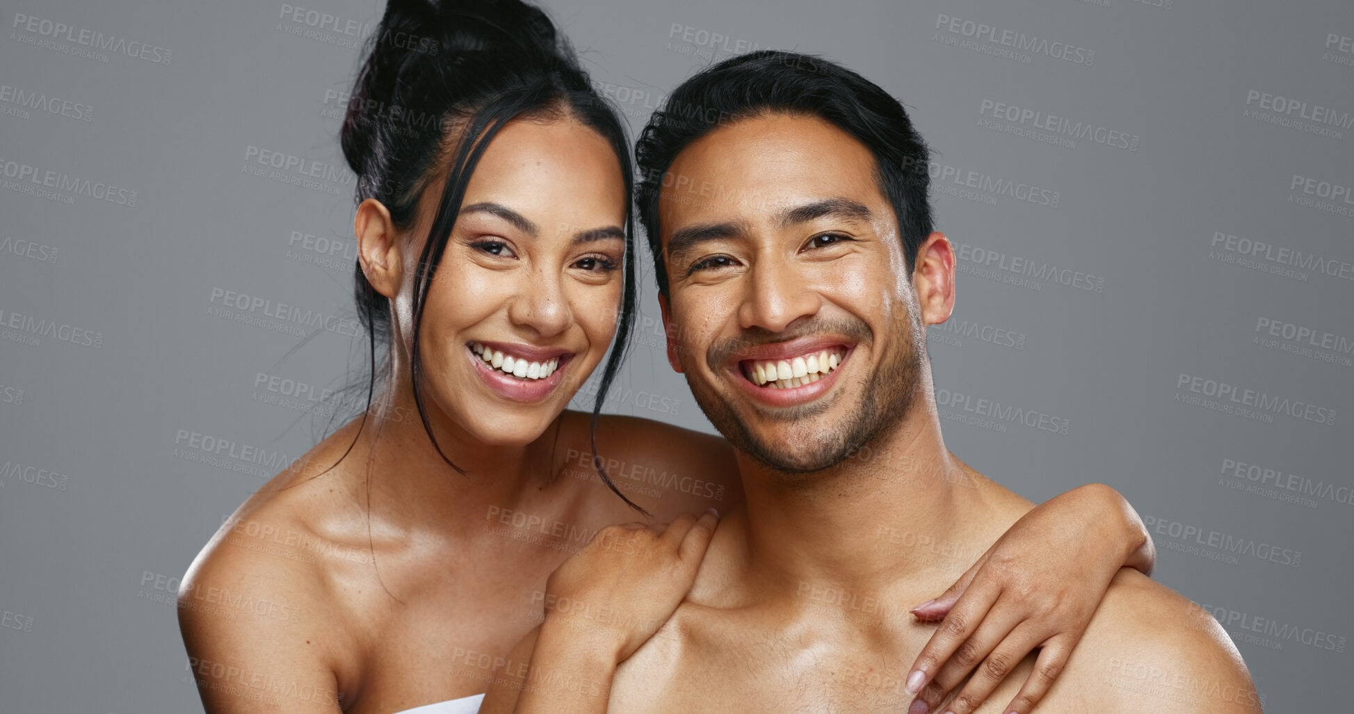 Buy stock photo Couple, smile and care for skincare, happy and portrait for wellness in studio by gray background. Happy people, dermatology and hug for cosmetics, hydration and glow or love for skin treatment