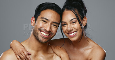 Couple, smile and care for skincare, love and portrait with moisturizer in studio by gray background. Happy people, dermatology and hug for cosmetics, hydration and creme or happy for skin treatment