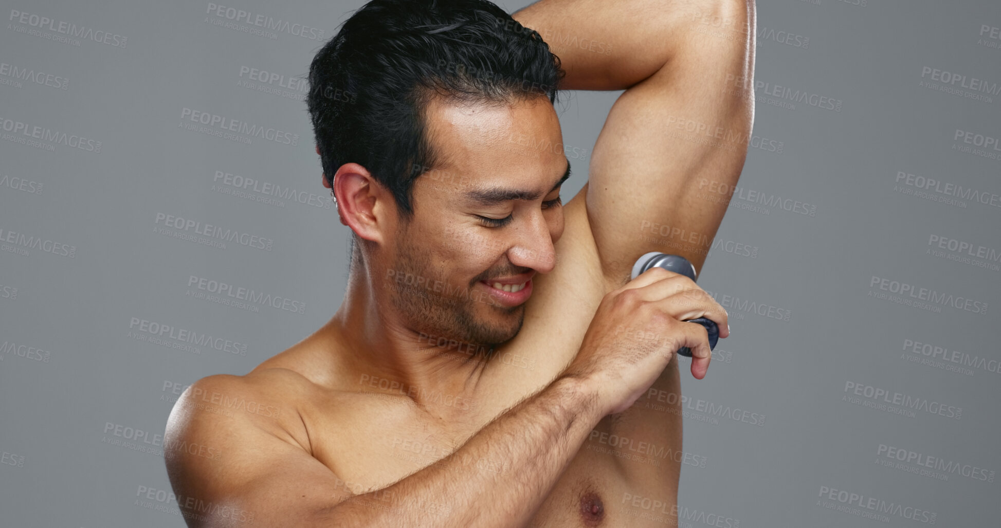 Buy stock photo Happy asian man, deodorant and armpit for hygiene, grooming or fresh smell in against a grey studio background. Male person smile for cleaning, cosmetics or self care in skincare or product on mockup