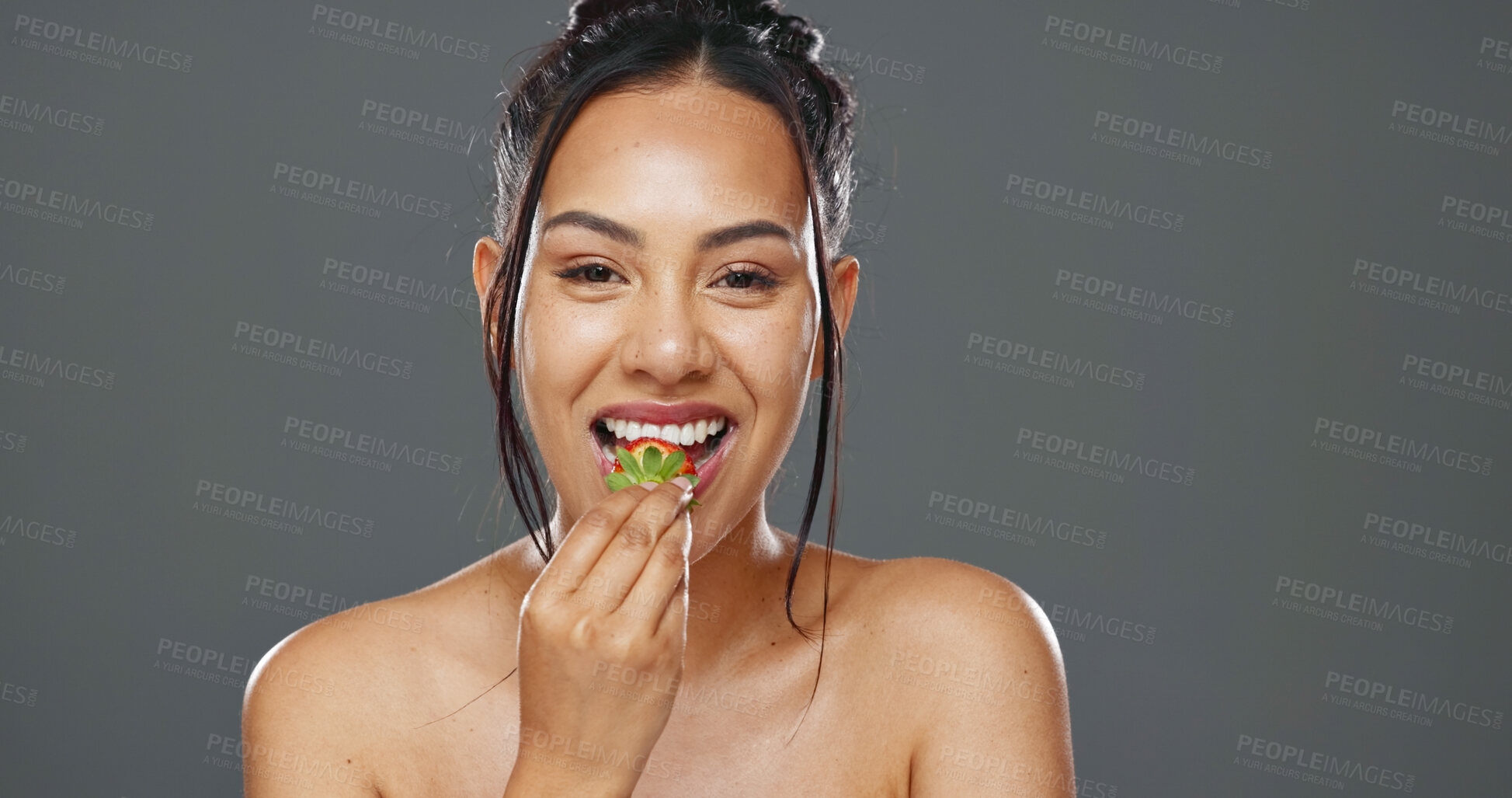 Buy stock photo Woman, strawberry and beauty in studio for health, diet and smile on face with skincare by background. Girl, model and happy for fruit, nutrition choice and vegan food for wellness, glow or self care