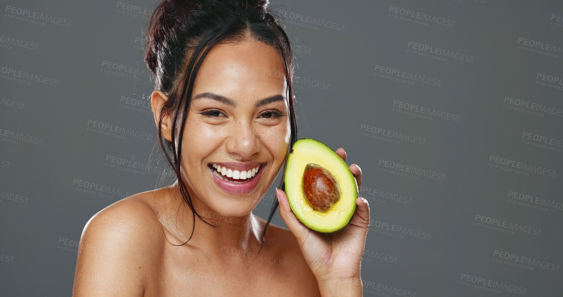 Buy stock photo Woman, avocado and beauty in studio for health, diet or smile on face for skincare by background. Girl, model or happy for fruit, nutrition choice or vegan food for wellness, natural glow or portrait