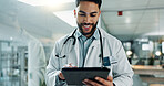 Tablet, research and happy man doctor on internet for medical or healthcare information online in a hospital. Smile, medicine and professional typing on health website or app in a modern clinic