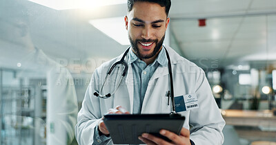 Tablet, research and happy man doctor on internet for medical or healthcare information online in a hospital. Smile, medicine and professional typing on health website or app in a modern clinic