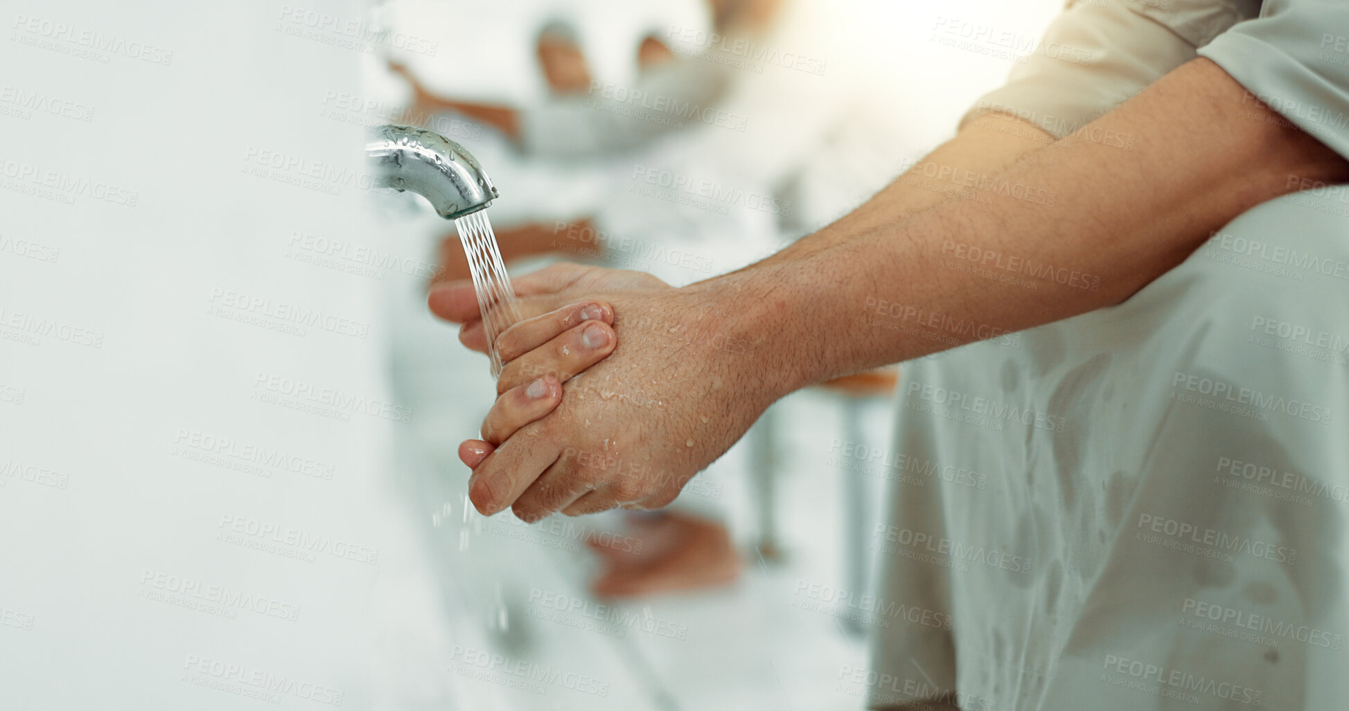 Buy stock photo Muslim, community and person washing hands with holy water after praying in a mosque bathroom for faith or religion. Islamic, culture and Arabic spiritual cleaning as care, worship or ritual