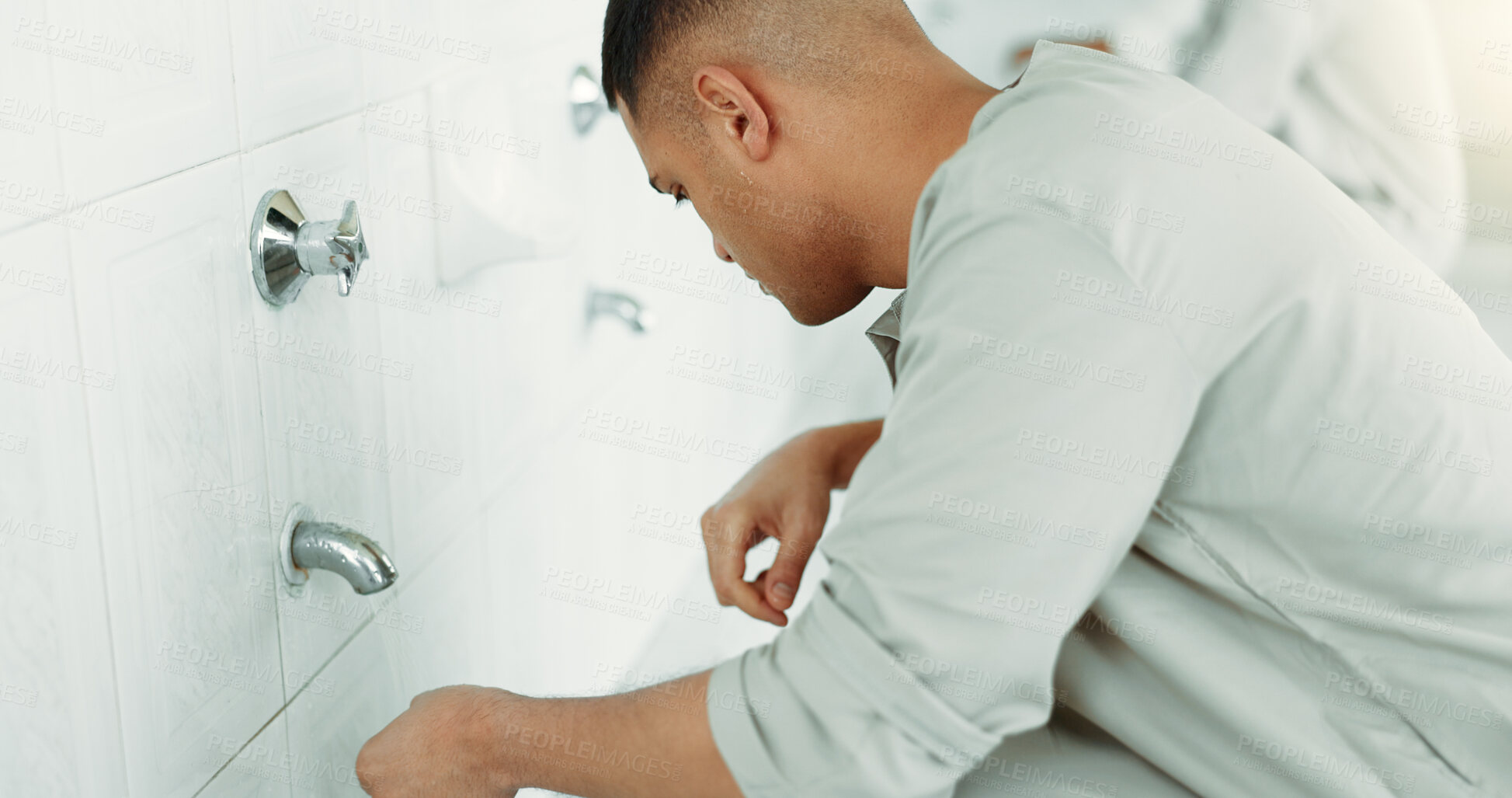 Buy stock photo Muslim, religion and man ear washing for prayer in bathroom for purity, and cleaning ritual. Islamic, worship and faith of group of people with wudu together at a mosque or temple for holy practice