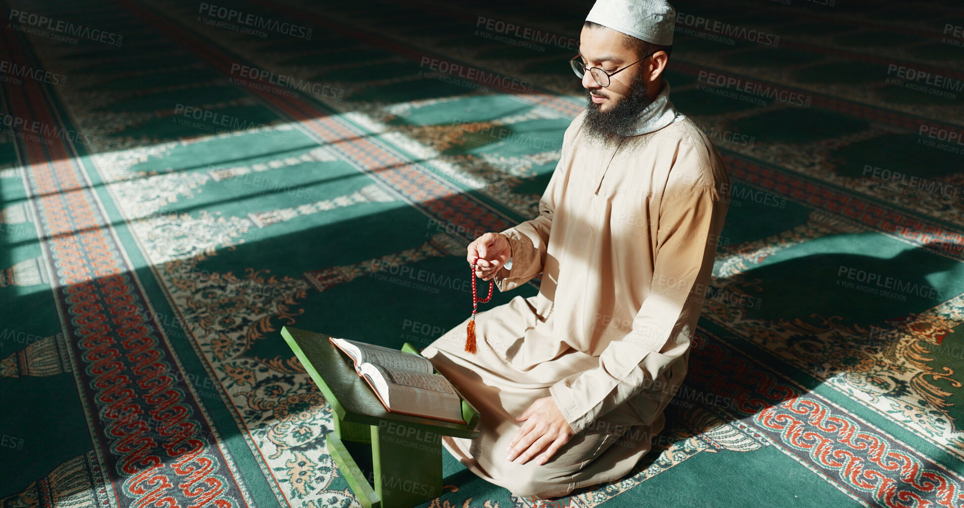 Buy stock photo Islam, praying and man in mosque with Quran, mindfulness and gratitude in faith reading. Worship, religion and Muslim Imam in holy temple for praise with book, spiritual teaching and peace meditation