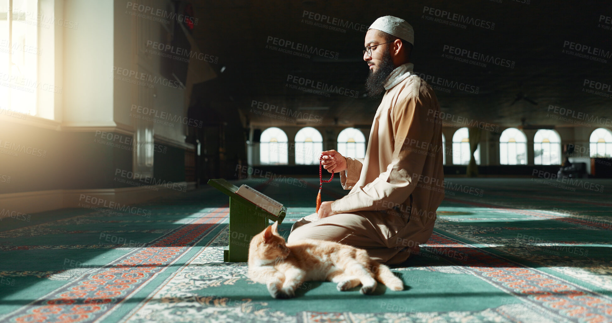 Buy stock photo Quran, islamic and man with faith in a mosque for praying, peace and spiritual care in holy religion for Allah. Reading book, Ramadan and Muslim person with beads, hope or grastitude to worship God