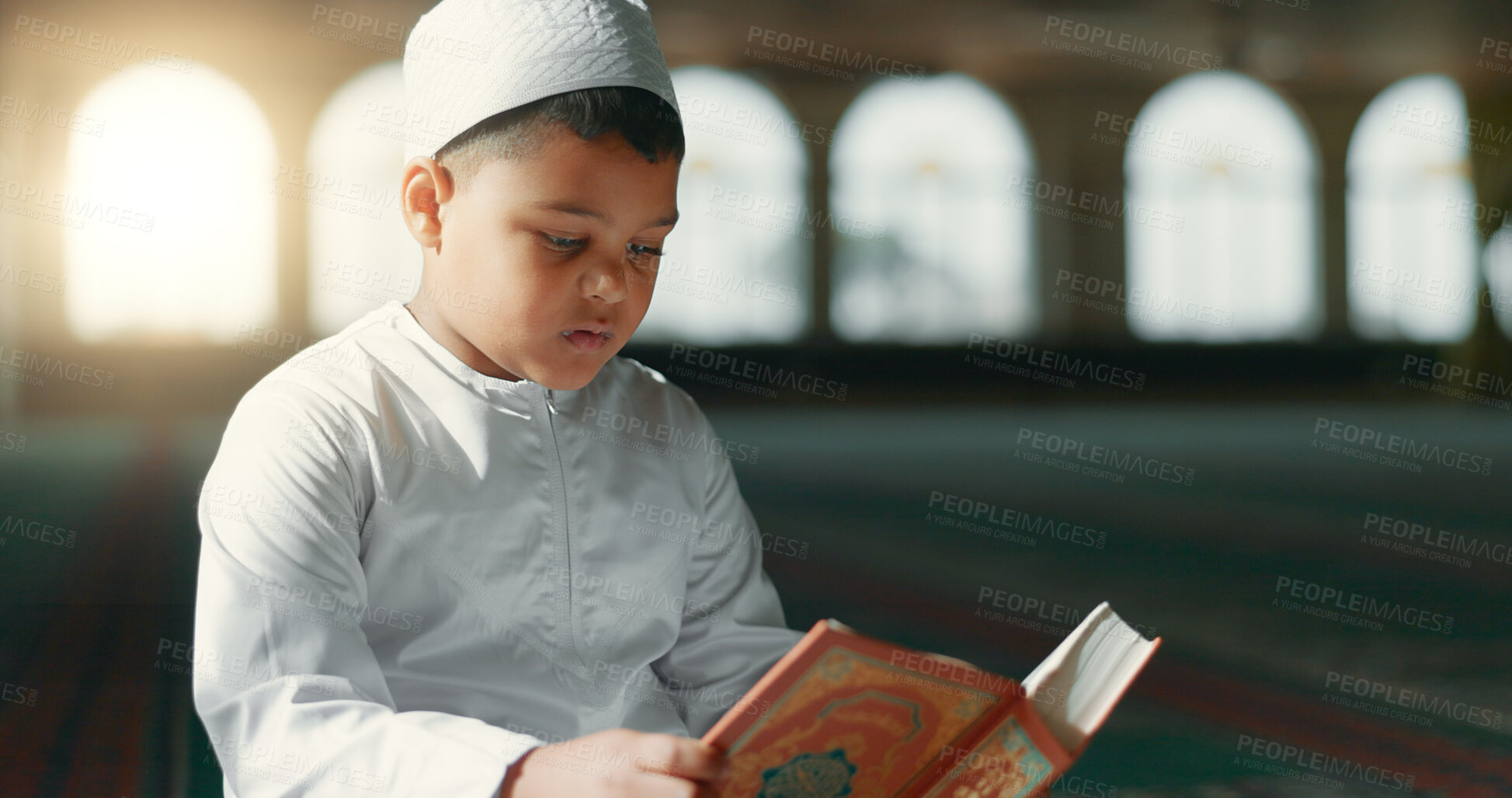 Buy stock photo Islam, child in mosque reading Quran for learning, mindfulness and gratitude in faith with prayer. Worship, religion and Muslim student in holy temple praise with book, spiritual teaching and study.