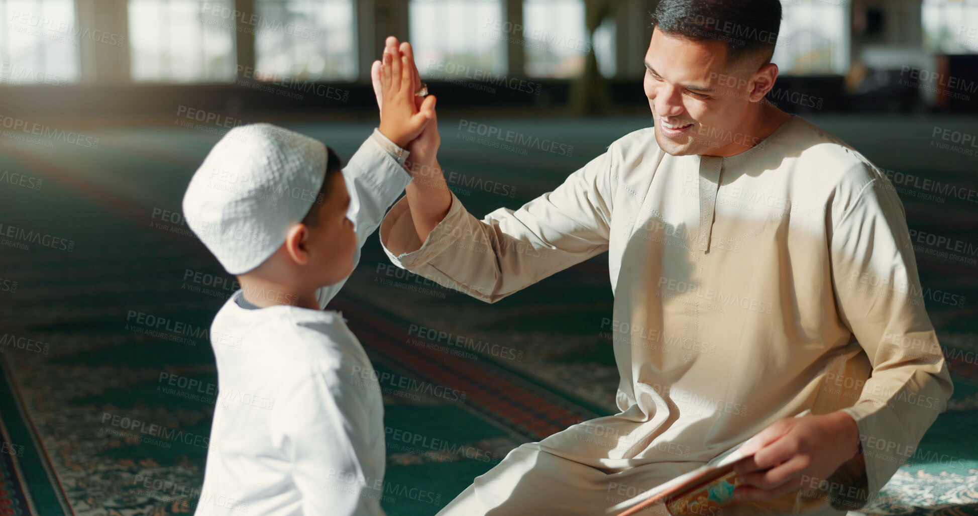 Buy stock photo Muslim, high five in a mosque and a father with his son to study the quran for faith, belief or religion together. Family, kids and ramadan with a man teaching his boy child about islamic success