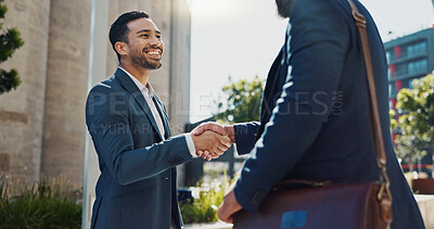 City, business people and handshake with happy employees and smile from project deal and success. Conversation, teamwork and outdoor with staff and urban building with speaking and shaking hands
