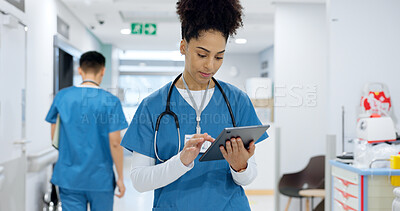 Woman, doctor and tablet walking at hospital for research, schedule planning or communication in hallway. Female person, nurse or medical worker with technology for Telehealth or networking at clinic