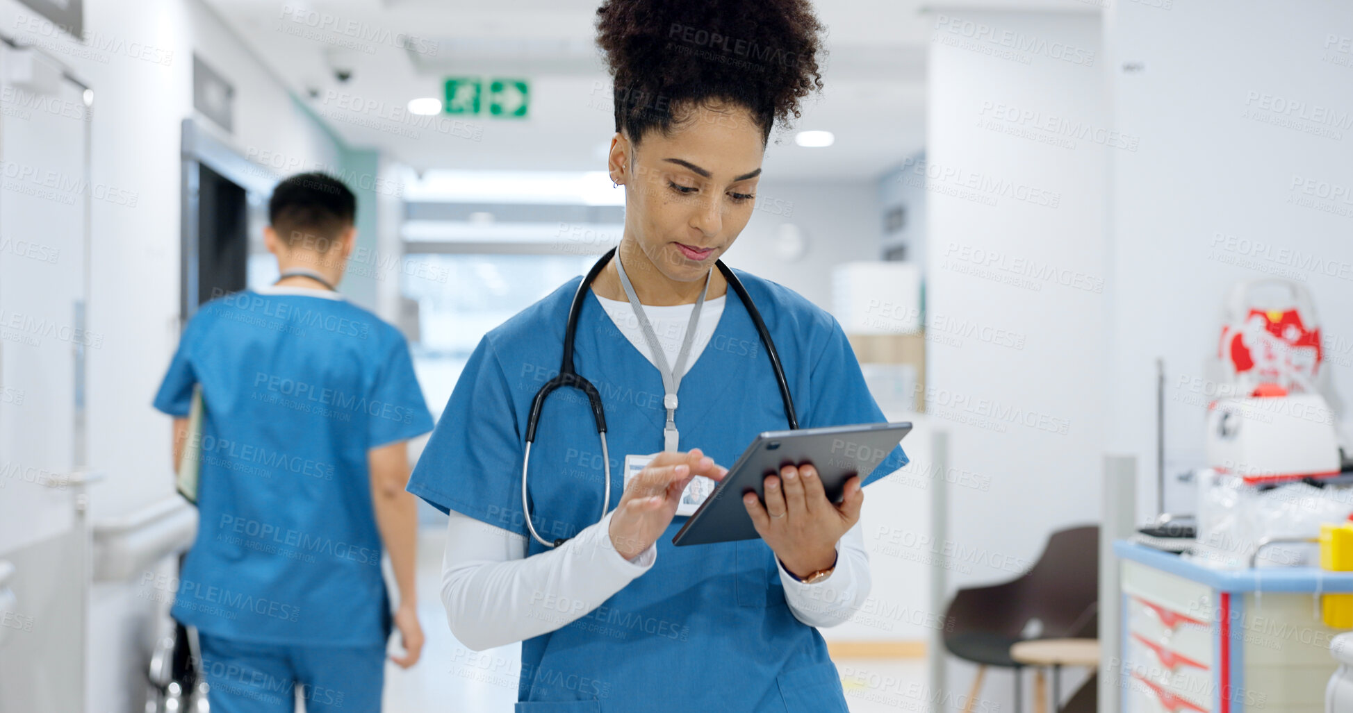 Buy stock photo Woman, doctor and tablet walking at hospital for research, schedule planning or communication in hallway. Female person, nurse or medical worker with technology for Telehealth or networking at clinic