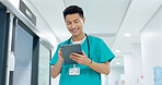 Doctor, nurse and smile on tablet for hospital services, thinking of healthcare and typing information online. Medical worker or Asian man in China with digital technology, clinic inspection or ideas