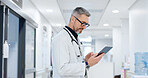 News, tablet or mature doctor in hospital with research on website to search for medicine info online. Man reading, senior or medical healthcare nurse browsing on technology for telehealth in clinic