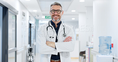 Professional, face and man or doctor with arms crossed for wellness, trust and service in hospital or clinic. Portrait, person and expert with happiness for career, cardiology or glasses at workplace