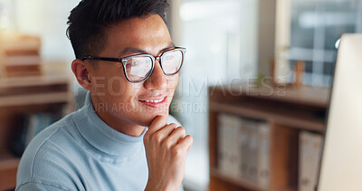 Asian man at computer, glasses and ideas, thinking and reading email, web review or article at digital agency. Research, reflection and businessman at tech startup networking on business website.