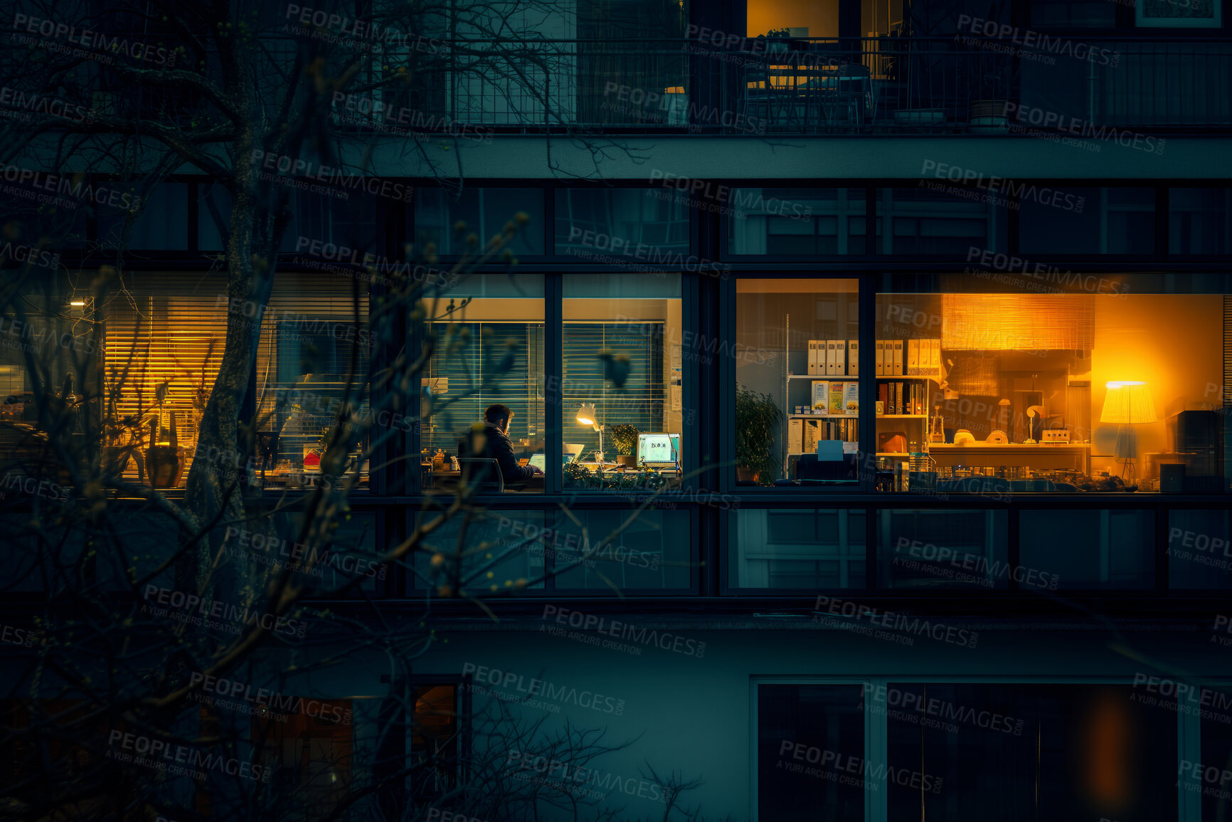 Buy stock photo Workspace, dark and employee working in an office late at night for overtime, deadline and project. Man, creative designer and alone in the workplace with light for business, energy and technology