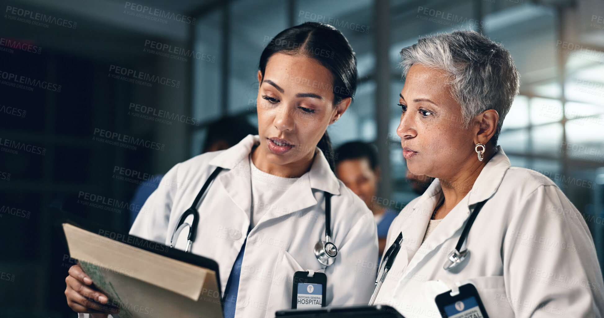 Buy stock photo Doctor, women together and tablet in night, documents or analysis for results, decision or info in hospital. Mature medic, partnership and paperwork for healthcare, wellness and planning with choice