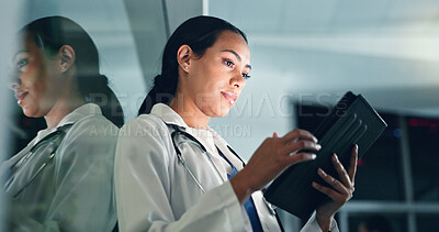 Doctor, woman and tablet at night with medical, healthcare and clinic data for research. Female professional, employee and telehealth with online consulting on a web app for wellness and planning