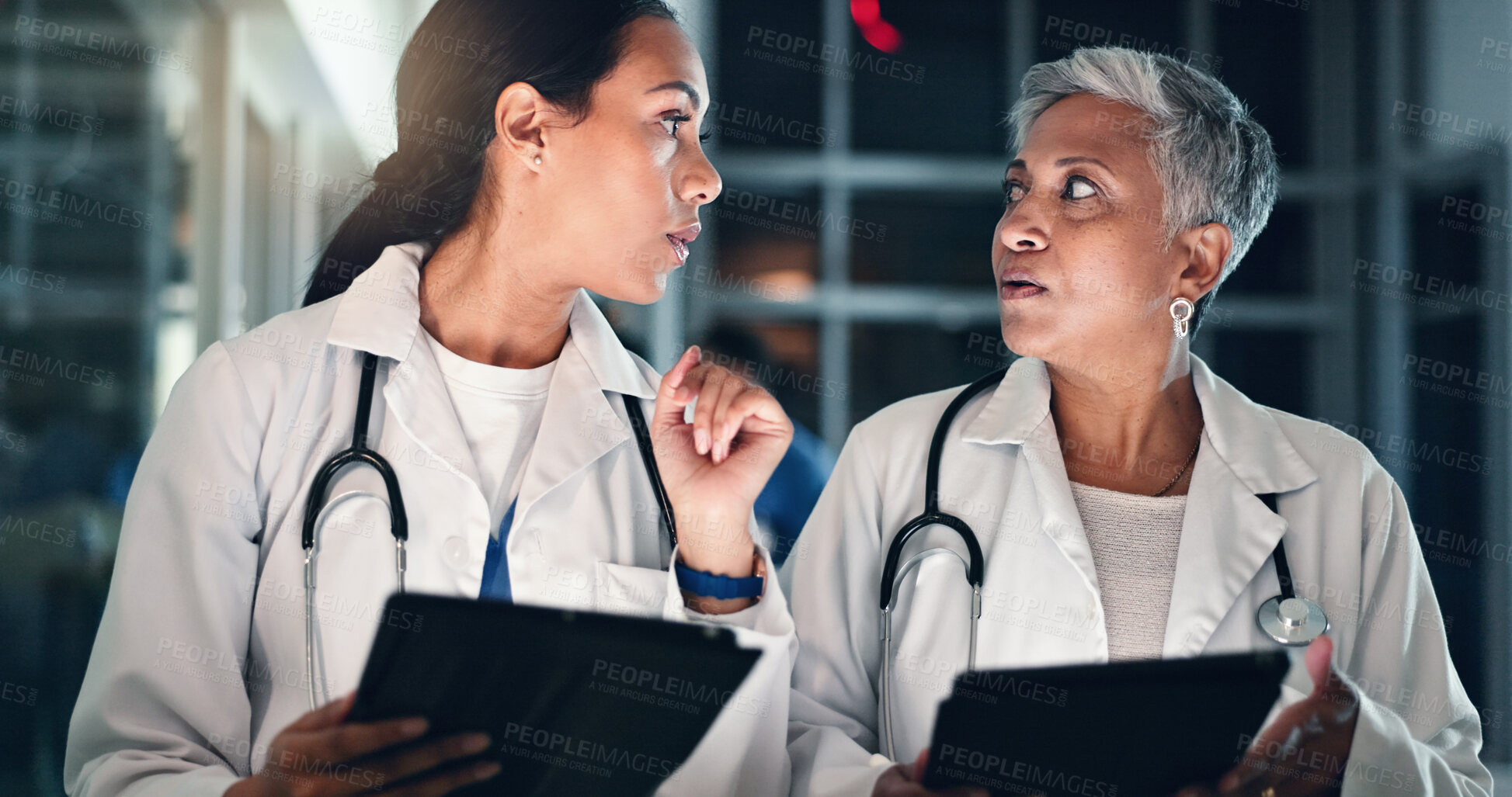 Buy stock photo Doctors night planning and tablet with talking, medical data and research in a hospital with women. Working, online and diagnosis discussion for healthcare, wellness and clinic job with conversation