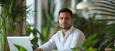 Man, laptop and business portrait in an office for environment, sustainability and nature. Confident, male executive sitting alone for marketing, eco strategy and leadership in green workplace