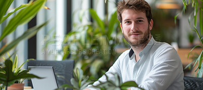 Man, laptop and business portrait in an office for environment, sustainability and nature. Confident, male executive sitting alone for marketing, eco strategy and leadership in green workplace