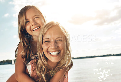 Buy stock photo Family, children and a mother with her daughter on the beach during summer for bonding on vacation. Portrait, love and kids with a woman carrying a female child on her back on the coast by the ocean