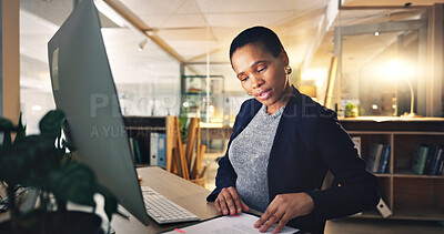Business woman, computer and typing with document at a desk for data entry in an office. African entrepreneur person working at a desktop with paperwork for information, research or online report