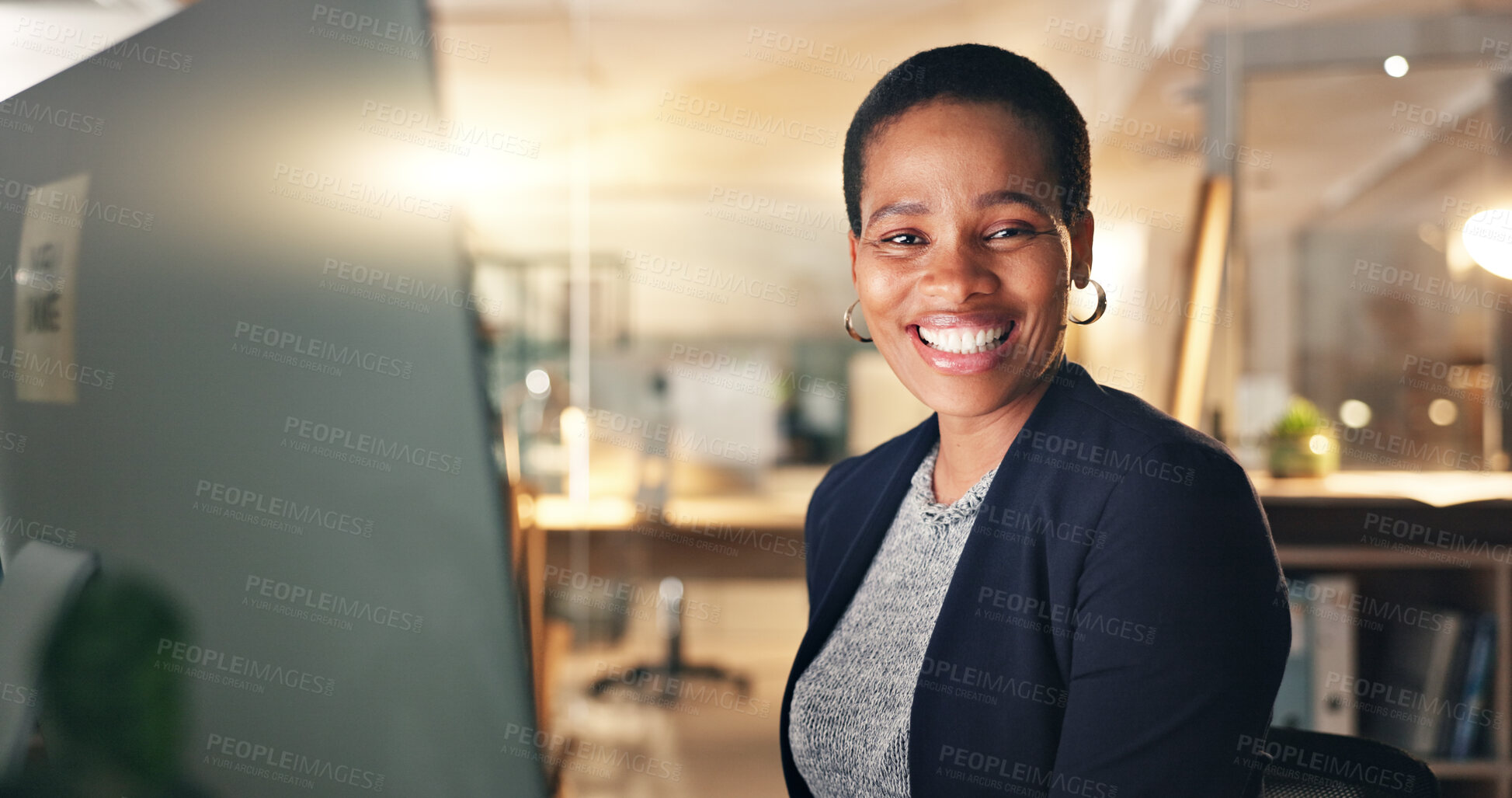 Buy stock photo Face, happy and black woman in office at night for business on a computer during overtime. Smile, workspace and portrait of an African employee with a pc for a late deadline or working in corporate