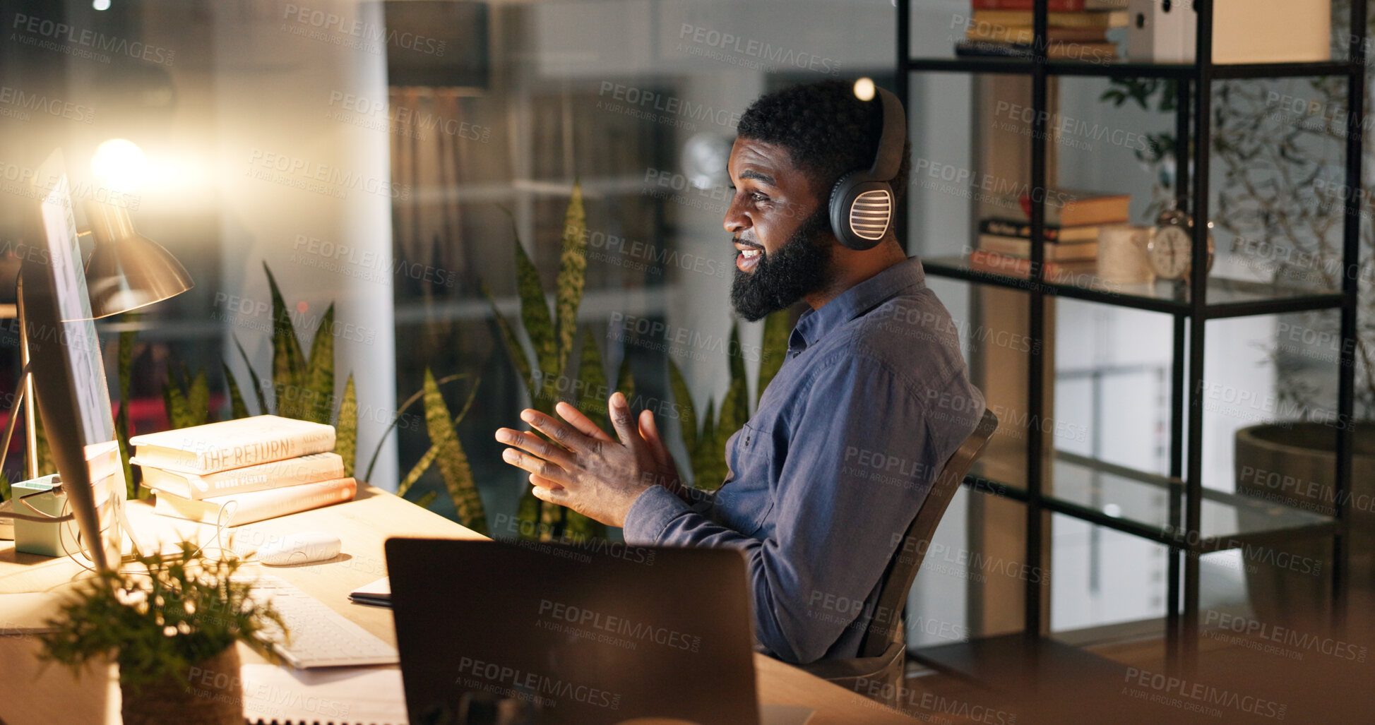 Buy stock photo Night, business and video call with black man, office and professional with communication, headphones and computer. Employee, entrepreneur and PR consultant with pc or talking with online meeting