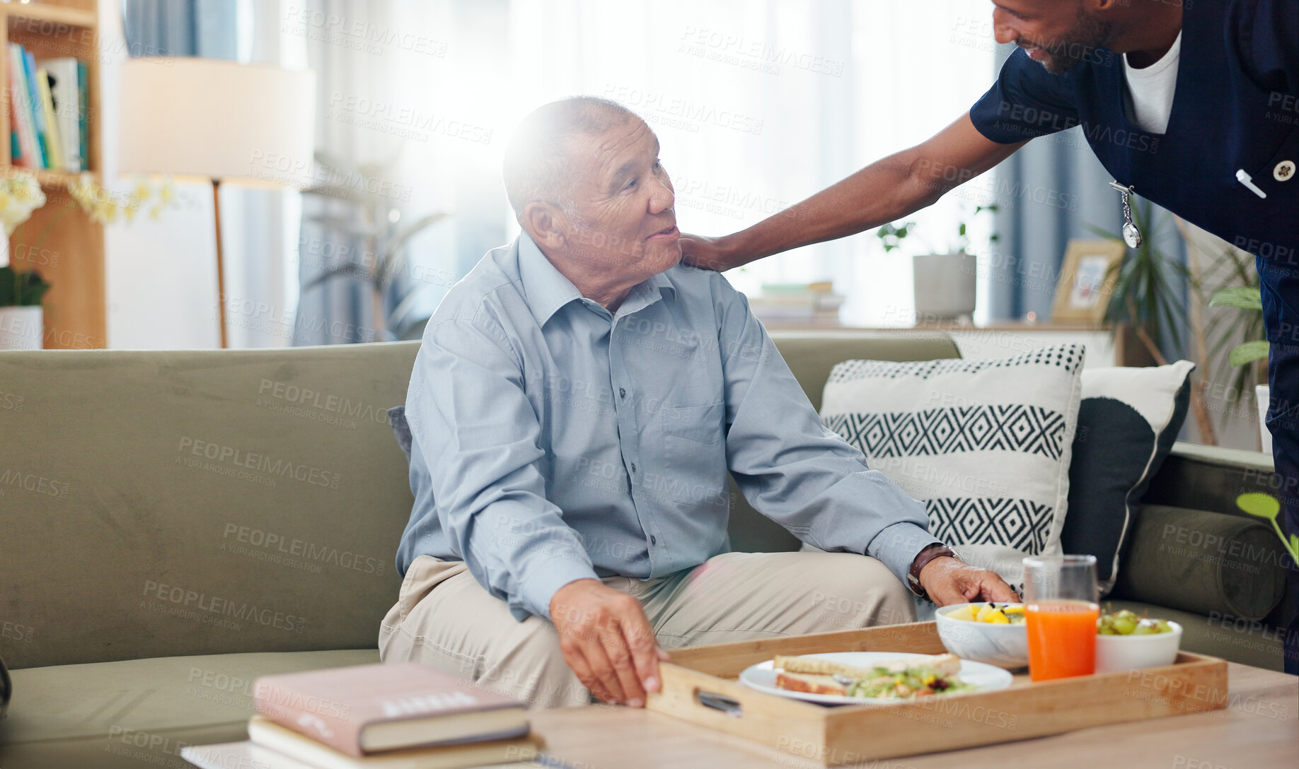 Buy stock photo Senior, woman and nurse or breakfast with support, conversation and caregiver in living room of retirement. Elderly, person and black man with kindness, happiness and discussion while serving a meal