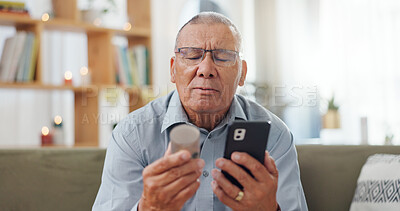 Phone, pills and senior man at home, reading label, medicine information and confused for telehealth service or FAQ. Elderly person on sofa with pharmaceutical bottle or tablet with mobile questions