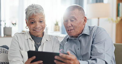 Senior, couple and tablet on sofa for online streaming, reading ebook or planning for retirement at home. Elderly people with digital technology for internet, happy with online choice and discussion