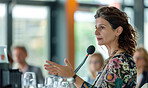 Businesswoman, conference or speaker sharing information at a business seminar for knowledge, motivational or coaching. Confident, woman or coach speaks to audience at a convention or corporate event
