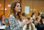 Businesswoman, conference or speaker sharing information at a business seminar for knowledge, motivational or coaching. Confident, woman or coach speaks to audience at a convention or corporate event