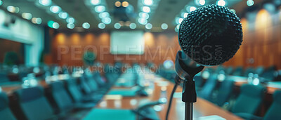 Microphone, public speaking and conference setup in an empty hall for event planning, convention and workshop. Closeup, banner and equipment for corporate business, marketing strategy or announcement
