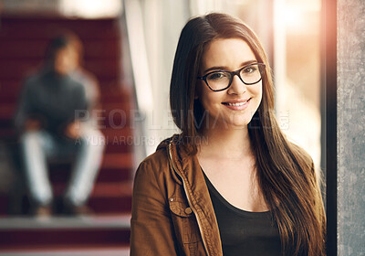 Buy stock photo Cropped portrait of an attractive young university student standing in a hallway on campus