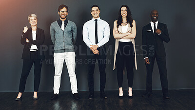 Buy stock photo Studio portrait of a group of businesspeople standing against a grey background