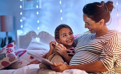Buy stock photo Cropped shot of an attractive young woman reading her daughter a bedtime story
