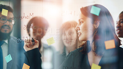 Buy stock photo Business people, glass wall and woman writing, brainstorming and strategy in office. Sticky notes, planning and group of employees working on ideas, schedule and collaboration for teamwork at work.