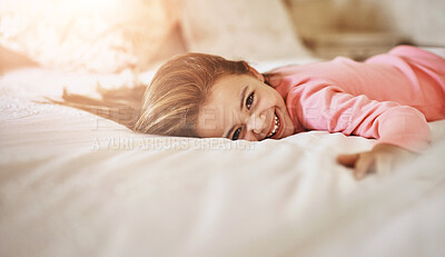 Buy stock photo Shot of a little girl lying on bed