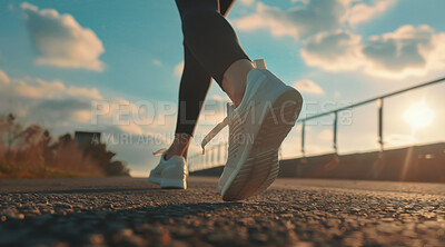 Female, running and athlete exercise in the morning for marathon competition, training or jogging workout alone. Low angle, sunrise and sport woman shoes mockup for challenge, technology or fitness