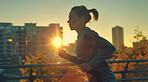 Woman, running and athlete on a morning run in the city for training, fitness and workout. Confident, determined and focused female jogging at sunrise for marathon training, competition or exercise