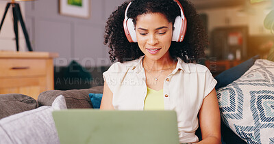Woman, headphones and laptop on sofa, relax and listening with audio streaming subscription in home living room. Girl, person and computer with smile for search, hearing and sound on lounge couch
