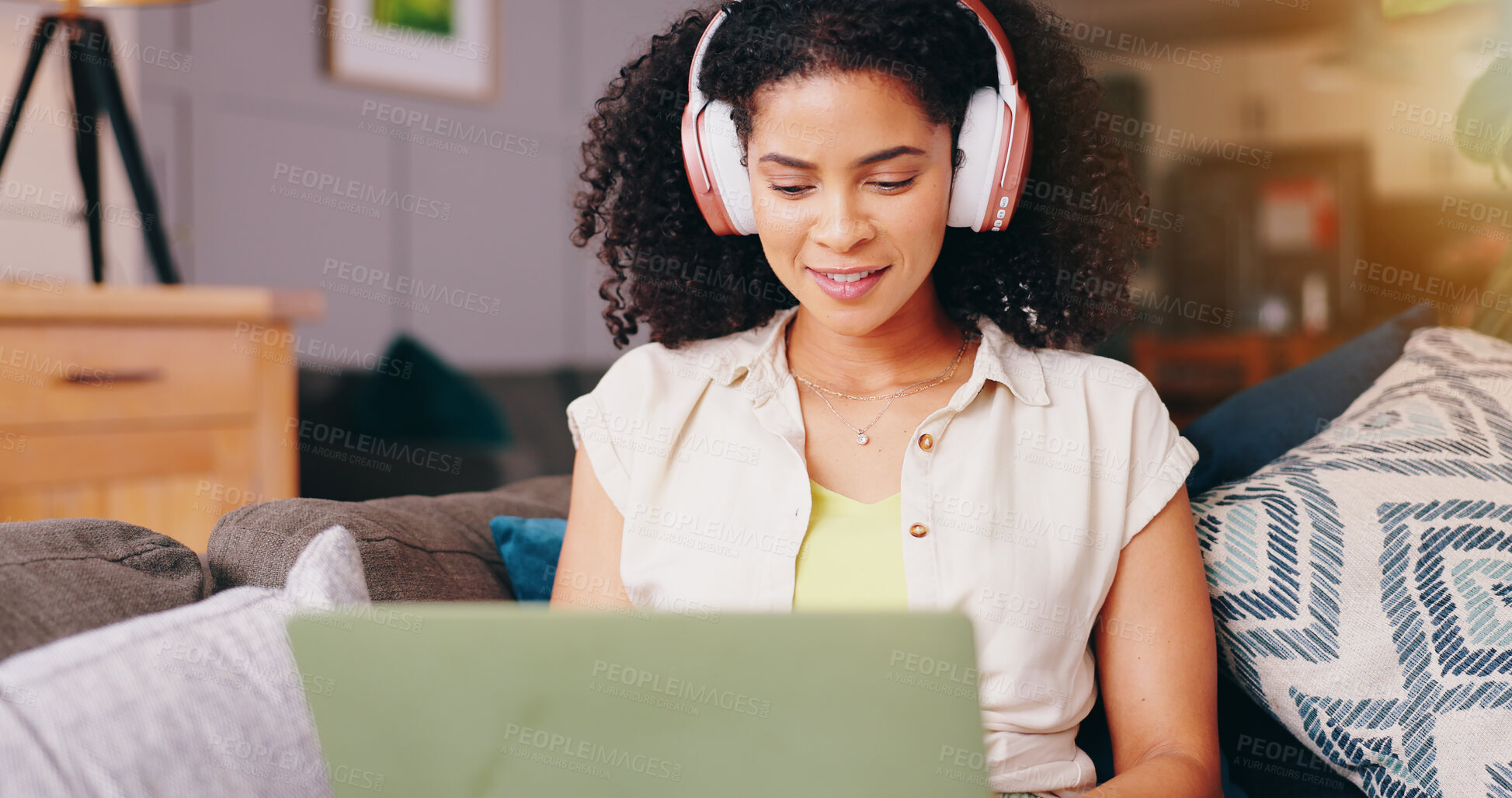 Buy stock photo Woman, headphones and laptop on sofa, relax and listening with audio streaming subscription in home living room. Girl, person and computer with smile for search, hearing and sound on lounge couch